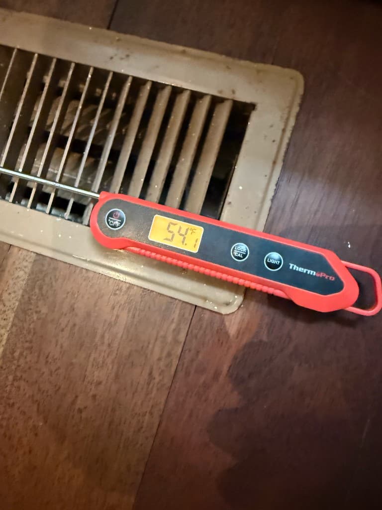 Supply air temperature check at floor register — residential comfort