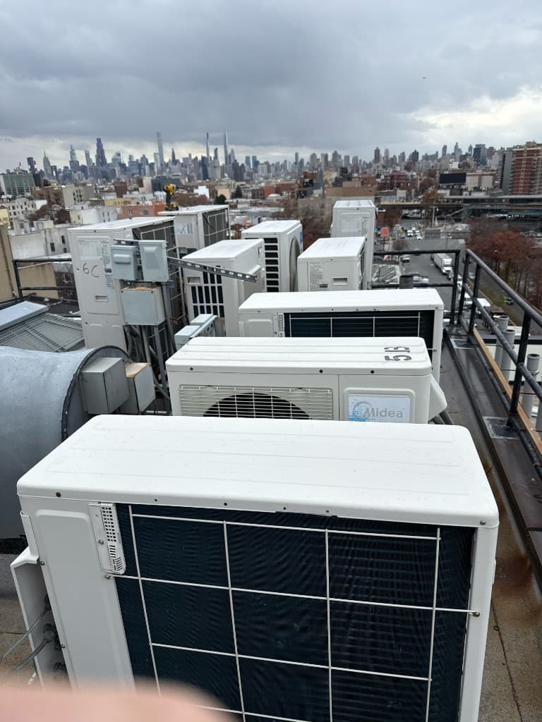 Commercial rooftop HVAC units with city skyline
